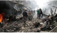 People walking through wreckage of buildings and damaged stores are seen after warcrafts belonging to Syrian army bombed a bazaar in Maarrat al-Nu'man, south of Idlib, Syria on April 19, 2016.