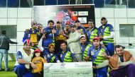 Al Hamra CC players and officials pose with the trophy after winning the final. 