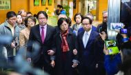 Selina Tsang (centre), wife of former Hong Kong Chief Executive Donald Tsang, is accompanied by her two sons, Simon Tsang Hing-yin (centre left) and Thomas Tsang Hing-shun (centre right), as they leave the High Court, in Hong Kong, yesterday.
