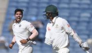 India's Umesh Yadav (L) celebrates after the dismissal of Australia's Nathan Lyon (R) on the first day of the first Test cricket match between India and Australia at the Maharashtra Cricket Association stadium in Pune on February 23, 2017. (AFP / INDRANIL