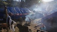 This file photo taken on January 21, 2017 shows refugees in front of their temporary shelter near Lung Byeng village, Waimaw township in Kachin state. The head of Myanmar's most powerful ethnic rebel group has warned that fighting in the country's restive