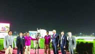 Victorious horse Majeed's owner and Qatar Racing and Equestrian Club officials pose for a photograph during the H H the Emir’s Sword Racing Festival at Al Rayyan Racecourse yesterday.