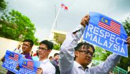 Members of the youth wing of the National Front, hold placards during a protest at the North Korea embassy in Kuala Lumpur, yesterday.