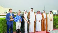 The winning team of Ebraz consisting of British jockey Alan Munro, American trainer Julian Smart and owner H E Sheikh Mohammed bin Khalifa Al Thani, pose for a picture with Emir HH Sheikh Tamim bin Hamad Al Thani, during the award ceremony of the Emir’s S