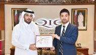 Salem Al Mannai (left), Deputy Group President & CEO of QIC MENA region, handing over certificate of appreciation to trainee Yuji.