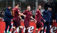 AS Roma's Belgium midfielder Radja Nainggolan (C) is congratulated by teammates after scoring his second goal during the Italian Serie A football match Inter Milan vs AS Roma at the San Siro stadium in Milan on February 26, 2017. / AFP / MIGUEL MEDINA
