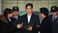 (FILES) In a file photo taken on February 22, 2017 Lee Jae-Yong (C), vice chairman of Samsung Electronics, arrives for questioning at the office of a special prosecutor investigating a corruption scandal in Seoul. AFP / JUNG YEON-JE