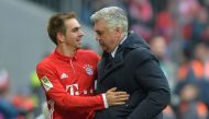 Bayern Munich's Italian head coach Carlo Ancelotti thanks Bayern Munich's defender Philipp Lahm (L) during the German first division Bundesliga football match between Bayern Munich and Hamburger SV in Munich, southern Germany, on February 25, 2017.  AFP /