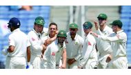 Australia's Steve O'Keefe (third left) is congratulated by team-mates after his dismissal of India's Murali Vijay on the third day of their first Test in Pune on February 25. Australia will head into the Bengaluru Test  with a 1-0 lead.   