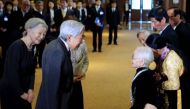Nguyen Thi Xuan (right), 92, who married a former Japanese soldier, greets Japan's Emperor Akihito and Empress Michiko as they meet at a hotel in Hanoi with family members of Japanese veterans living in Vietnam on Thursday. | AFP-JIJI.