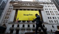 Signage for Snap Inc., parent company of Snapchat, adorns the front of the New York Stock Exchange (NYSE), March 2, 2017 in New York City. Snap Inc. priced its initial public offering at $17 a share on Wednesday and Snap shares will start trading on the N