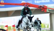 Moroccan rider Abdelkebir Ouaddar guides Cordano Sitte Z over an obstacle on his way to win the CSI5* Two Phases (274.5.3) 1.45m competition  at the Al Shaqab outdoor arena yesterday.  Picture by:  Salim Matramkot/ The Peninsula