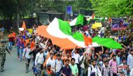 Students of Akhil Bharatiya Vidyarthi Parishad (ABVP) shout slogans as they carry India's national flag during a protest march, on the Delhi University campus, yesterday.