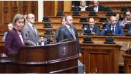 High Representative of the European Union for Foreign Affairs and Security Policy, Federica Mogherini (R) addresses the Serbian deputies at the Serbian National Assembly as opposition SRS party and Dveri Movement members of the assembly protest her in Bel