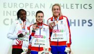 Winner Laura Muir (centre) and Eilish Mccolgan (third) of Britain and Yasemin Can of Turkey pose during the medals ceremony of women's 3000m at European Athletics Indoor Championship in Belgrade, Serbia on Sunday. 
