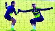 Arsenal striker Alexis Sanchez (left) and team-mater Lucas Perez are seen during a training session ahead of their UEFA Champions League round of 16 second leg match against Bayern Munich at Arsenal's London Colney training ground yesterday.