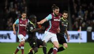  West Ham United's Andy Carroll in action with Chelsea's N'Golo Kante and Cesc Fabregas Reuters / Toby Melville