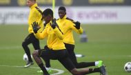 Dortmund's French midfielder Ousmane Dembele warms up during a training session in Dortmund, on March 7, 2017 on the eve of the Champions League football match between Borussia Dortmund and Benfica. / AFP / PATRIK STOLLARZ
