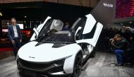 People look at a Tamo Racemo Sports Coupe by Indian carmaker Tata motors' sub-brand Tamo at the Indian carmaker stand during the first press day of the Geneva International Motor Show on March 7, 2017 in Geneva. Europe's biggest annual car show kicks off 