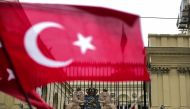 This picture taken on March 12, 2017, shows a Turkish national flag waved in front of the Dutch Consulate in Istanbul. AFP / YASIN AKGUL
