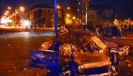 Burned cars seen on a street in Georgia's Black Sea port of Batumi during clashes between police and stone-throwing rioters following a protest by local residents against police officers arresting several men who refused to accept a parking fine. Nearly t