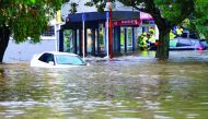 Rescue workers assist stranded people from floodwaters in the Auckland suburb of New Lynn in New Zealand