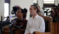 © Reuters. British national David Taylor sits in a courtroom with an interpretor during his sentencing over his role in the death of a police officer at the Denpasar District Court in Bali.