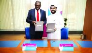 Rashid bin Ali Al-Mansoori, CEO of Qatar Stock Exchange (right) and  Geoffrey Otieno Odungo, CEO of Nairobi Securities Exchange exchanging documents in Doha.