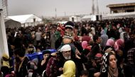 Displaced Iraqis from Mosul arrive at the Hamam al-Alil camp on March 13, 2017, during the government forces ongoing offensive to retake the western parts of the city from Islamic State (IS) group fighters. / AFP / ARIS MESSINIS
