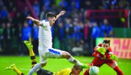 Dortmund's defender Matthias Ginter, Dortmund goalkeeper Roman Buerki (right) and Lottes Bernd Rosinger vie for the ball during the German Cup DFB Pokal quarter-final football match in Osnabruck, northern Germany. 