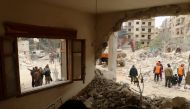 Civil Defence members and civilians remove rubble in a damaged site after an airstrike on Idlib city, Syria March 15, 2017. REUTERS/Ammar Abdullah
