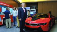 Vodafone Qatar CEO Ian Gray posing  for a picture in front of Vodafone's IoT powered Connected Car. Pic: Kammutty VP/The Peninsula.
