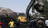 ADDIS ABABA, ETHIOPIA - MARCH 13: Rescue workers search for those buried by a landslide that swept through a massive garbage dump at Koshe rubbish tip in Kolfe Keranio district of Addis Ababa, Ethiopia on March 13, 2017. Minasse Wondimu Hailu - Anadolu Ag