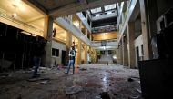 A reporter stands over blood stains after a suicide blast at the Palace of Justice in Damascus, Syria March 15, 2017. REUTERS/Omar Sanadiki
