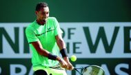 Nick Kyrgios of Australia returns a shot to Novak Djokovic of Serbia during the BNP Paribas Open at the Indian Wells Tennis Garden on Wednesday in Indian Wells, California. 