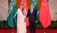 Chinese Premier Li Keqiang (R) shakes hands with The Custodian of the Two Holy Mosques King Salman bin Abdulaziz (L) of Saudi Arabia at Great Hall of the People in Beijing on March 17, 2017. AFP / POOL / Lintao Zhang