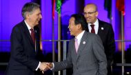 Japanese Finance Minister Taro Aso and Britain's Chancellor of the Exchequer Philip Hammond arrive for the family photo at the G20 Finance Ministers and Central Bank Governors Meeting in Baden-Baden, Germany, March 17, 2017. REUTERS/Kai Pfaffenbach
