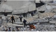 Civil defense units and people try to rescue victims who were trapped under the debris of a mosque after war crafts belonging to USA carried out series of airstrikes during night prayer in Al-Jineh village of Atarib district in Aleppo, Syria on March 17, 