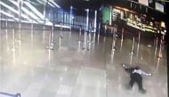 An airport CCTV screen image shows a man on the ground inside Orly Sud terminal following a shooting incident at Orly Airport near Paris, France March 18, 2017. REUTERS/CCTV via Twitter