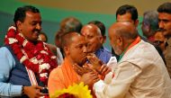 India’s ruling Bharatiya Janata Party (BJP) leader Yogi Adityanath (C) is offered sweets after he was elected as Chief Minister of India’s most populous state of Uttar Pradesh, during the party lawmakers' meeting in Lucknow, India March 18, 2017. REUTERS/