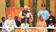 In this handout photograph released by The Indian Press Information Bureau (PIB) on March 19, 2017, India's Prime Minister Narendra Modi (2L) looks on as The Governor of the northern Indian state of Uttar Pradesh Ram Naik (C) presides over the swearing-in
