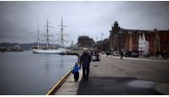 FILE PHOTO - A man walks with a child near the marina in downtown Bergen, southwestern Norway, March 20, 2012. REUTERS/Stoyan Nenov/File Photo
