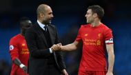 Manchester City's Spanish manager Pep Guardiola (L) speaks with Liverpool's English midfielder James Milner after the English Premier League football match between Manchester City and Liverpool at the Etihad Stadium in Manchester, north west England, on M