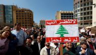 Protesters take part in a demonstration against a proposed tax increase, in front of the government palace in Beirut, Lebanon March 19, 2017. The placard reads in Arabic 