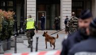 French gendarmes with a detection dog and police stand in front of the French financial prosecutor's offices following a bomb alert in central Paris, France, March 20, 2017. REUTERS/Benoit Tessier