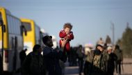 Rebel fighters and their families that evacuated the besieged Waer district in the central Syrian city of Homs, after an agreement reached between rebels and Syria's army, arrive on the southern outskirts of the Syrian city of al-Bab, Syria March 19, 2017