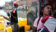 A man waits for his jerrycan to be filled at a public fountain during a period when the public water supply has been cut off, in the Isotry district of Antananarivo, Madagascar on March 17, 2017. 
/ AFP / RIJASOLO
