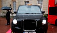 (FILES) This file photo taken on October 21, 2015 shows a TX5 London taxi made by Chinese company Geely pictured outside Lancaster House in central London, on October 21, 2015. AFP / ADRIAN DENNIS
