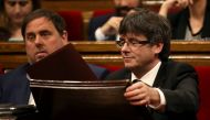 Catalonia's regional President Carles Puigdemont (R) and Economy Minister Oriol Junqueras attend a parliamentary session to vote on budgets, in Barcelona, Spain, March 22, 2017. REUTERS/Albert Gea
