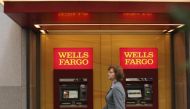 A woman walks past teller machines at a Wells Fargo bank in San Francisco, California in this October 10, 2013 file photo. REUTERS/Robert Galbraith